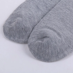 Close-up of grey cotton sock showing reinforced toe stitching and knit texture detail