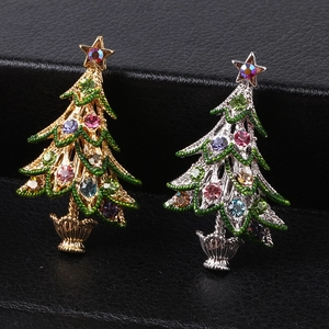Detail of Christmas tree brooches with colorful rhinestones in gold and silver finishes