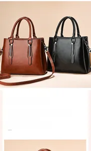 Close-up of minimalist faux leather handbags with sleek metal hardware and top handles