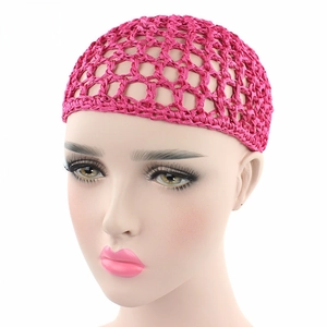 Detail of rose pink handmade crochet hair net with elastic mesh pattern for styling