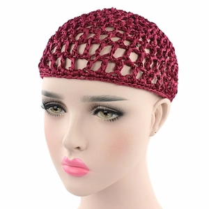 Close-up of a handmade crochet mesh snood in wine red with a delicate bow detail