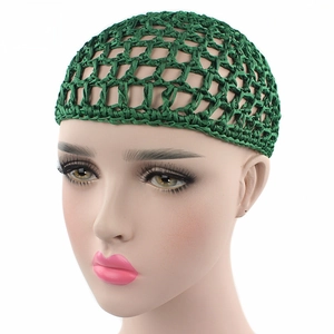 Detail showing green crochet hair net on a mannequin head with mesh pattern