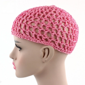 Close-up of pink handmade crochet hairnet with mesh hollow design and bow accent