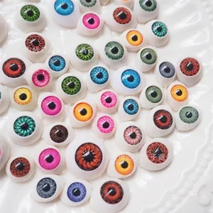 Macro detail of 20mm transparent glass doll eyes in multiple colors for DIY crafts