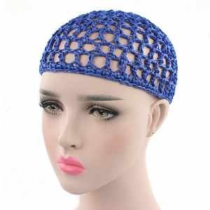 Close-up of blue handmade crochet hair net with elastic mesh structure on mannequin