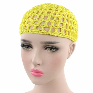 Detailed view of handmade yellow crochet hair net with intricate mesh weave and bow