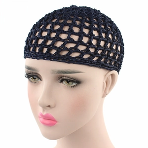 Detail of black handmade crochet hair net with wide mesh and elastic edge on a model head