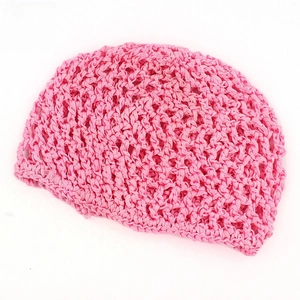 Macro detail of hand-crocheted hair net with honeycomb mesh in bright pink finish