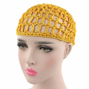 Detail of yellow handmade crochet hair net with large diamond mesh and reinforced edge