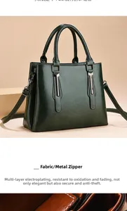 Detailed view of dark green leather handbag with polished silver hardware and fabric texture