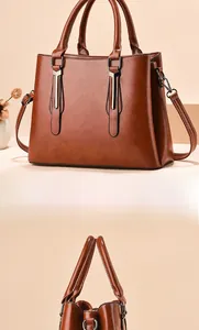 Close-up of vintage brown PU leather handbag with dual handles and detachable shoulder strap