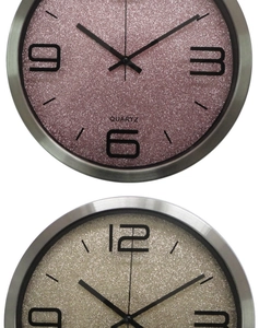 Close-up of glitter pink and champagne gold wall clocks with brushed silver metal frame