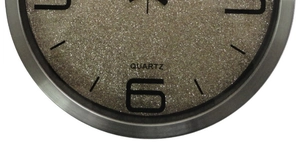 Close-up of champagne gold sand texture dial with quartz logo on stainless steel clock