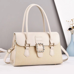 Elegante beige geweven handtas met hoefijzergesp met strass en gouden details