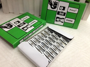 Macro view of boxed silver metal pencil sharpeners with green packaging on desk