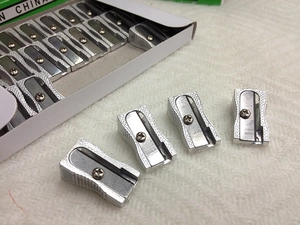 Macro view of silver aluminum alloy pencil sharpeners in a bulk pack set