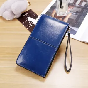 Dark blue long wallet for women in glossy oil wax leather with a wristlet strap