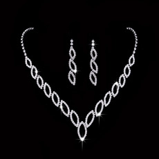 Macro shot of bridal necklace and earrings set with marquise-cut clear rhinestones