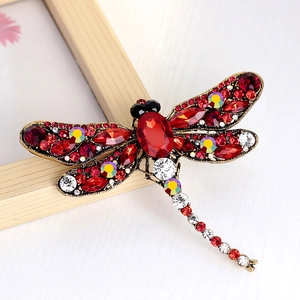 Vintage dragonfly brooch with large red stone and colorful crystals on antique gold base