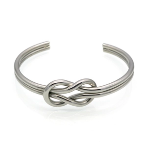 Polished silver stainless steel knot cuff bracelet with a minimalist knotted bow design