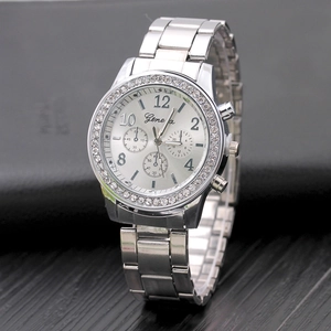 Silver Geneva alloy watch with sparkling rhinestones and metal chain strap on dark leather