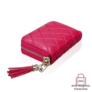 Detail of hot pink quilted leather RFID blocking card wallet with gold zipper and tassel