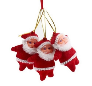Three Santa Claus ornaments with red suits and gold hanging ropes on a white backdrop