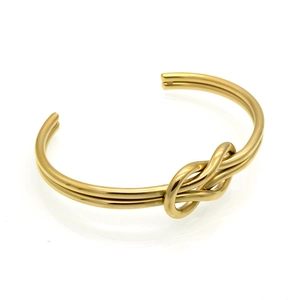 Detail showing the polished gold-plated double-line knot design on this minimalist cuff