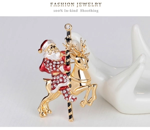 Detail of a Christmas brooch featuring Santa on a reindeer with red enamel and crystals