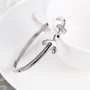 Minimalist silver stainless steel bracelet featuring a 3D anchor design on a white cup
