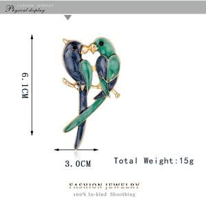 Detail showing dimensions of blue and green enamel bird brooch with gold metal frame
