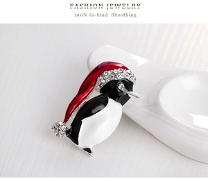 Detailed penguin brooch with red enamel hat and sparkling rhinestones for Christmas