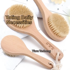 Detail of wooden bath brush set with natural bristles and hanging cotton rope