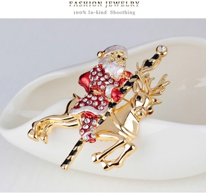 Detail of Santa Claus on golden reindeer brooch with enamel and sparkling crystals