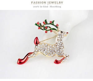 Detailed macro view of a reindeer brooch with pavé rhinestones and festive enamel accents