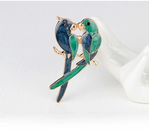 Detail of colorful parrot brooch in gold finish with blue and green enamel accents
