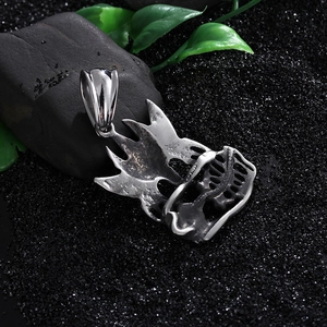 Gothic skull and eagle stainless steel pendant on a dark textured background