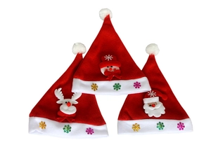 Detail showing three red plush Christmas hats with 3D snowman, reindeer, and Santa characters