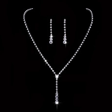 Macro detail of sparkling Y-shaped rhinestone heart necklace and drop earrings set