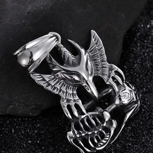 Polished silver eagle skull pendant on black stones with intricate Gothic metal wings
