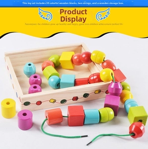 Detailed overhead view of 30 colorful wooden blocks with two threading laces in a tray