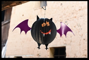 Hanging 3D paper bat decoration with black honeycomb body and purple wings for Halloween
