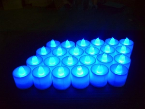Close-up of 21 blue LED flameless tea lights arranged in a grid for Halloween decor