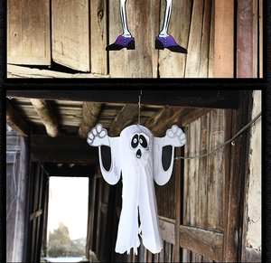Detail of Halloween ghost honeycomb paper decor and hanging skeleton legs with purple shoes