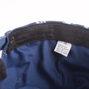 Interior detail of denim beret with black sweatband, 58cm size tag and cotton blend fabric