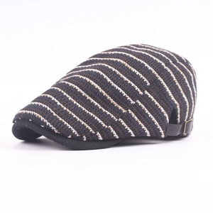 Detail of striped knitted newsboy cap with adjustable rear metal buckle and leather strap