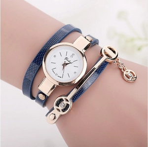 Detail of blue multi-layer wrap watch with rose gold case and sparkling crystals
