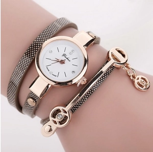 Macro shot of stylish wrap-around leather strap watch with rose gold angel charm