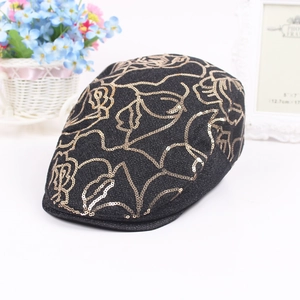 Close-up of elegant gold sequin rose embroidery on black knit beret hat for women