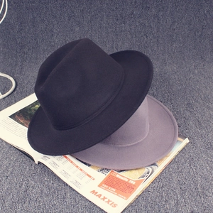 Close-up of wool felt fedora hats with grooved crown and ribbon on magazine
